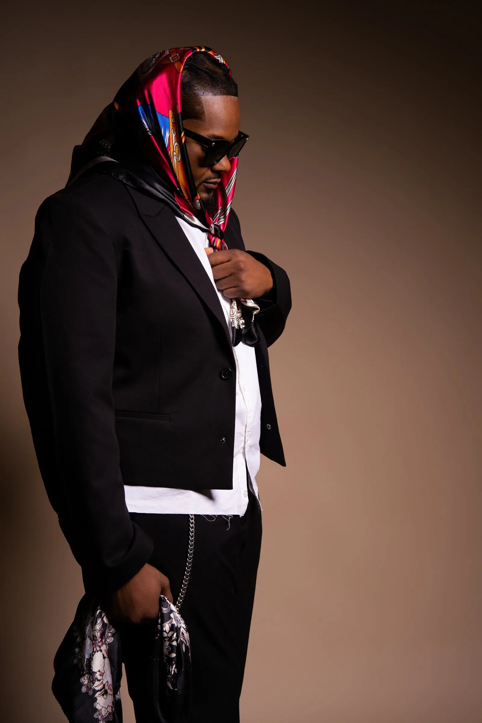 Men's fashion portrait in a black jacket and colorful scarf